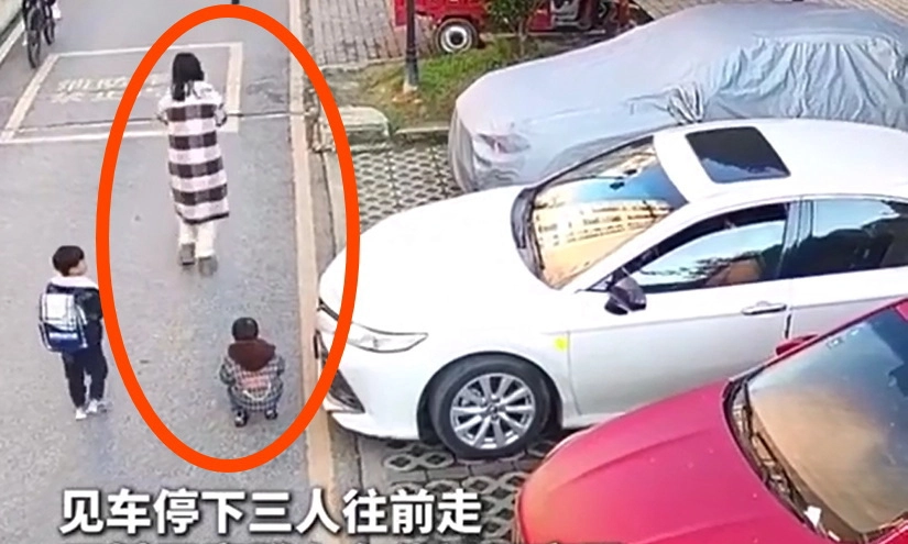 Video clip: Mẹ cắm cúi bấm điện thoại, bé trai suýt chết dưới gầm xe