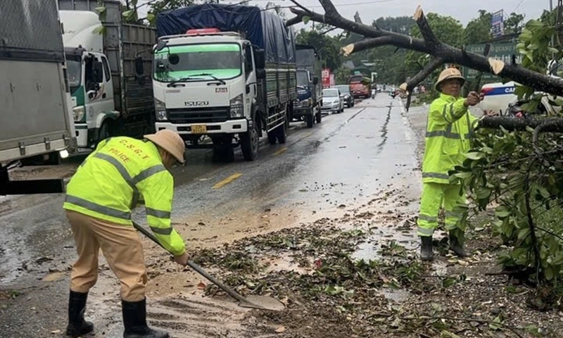 CSGT dọn cây đổ, đất đá đoạn ngập úng trên Quốc lộ 2