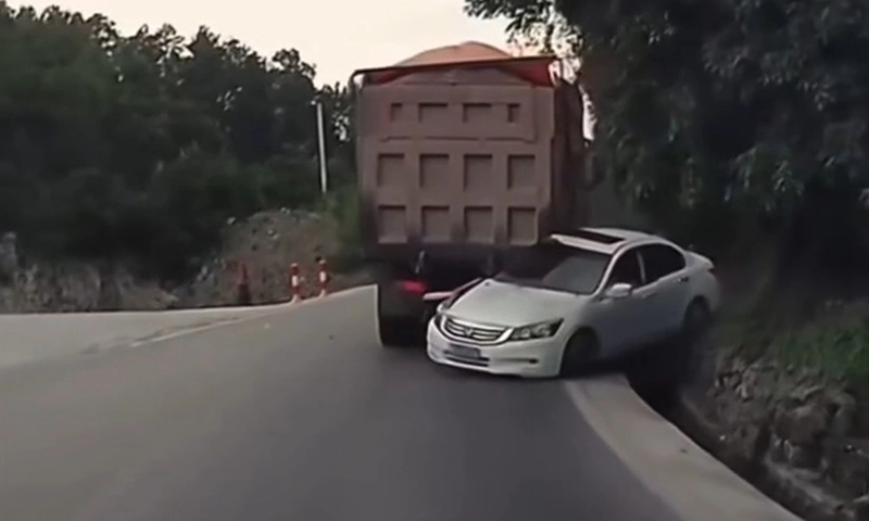 Xe tải tụt dốc ép ôtô con vào vách núi